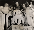 Photo of Eleanor Roosevelt cutting birthday cake.